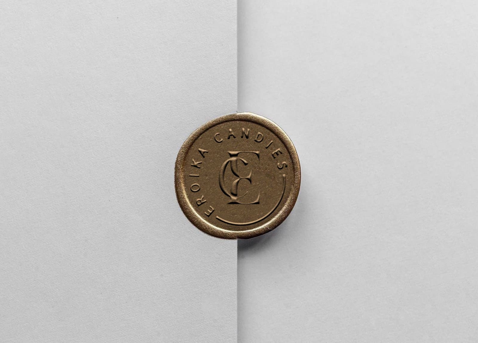 The wax-seal monogram and the ornate brand crest